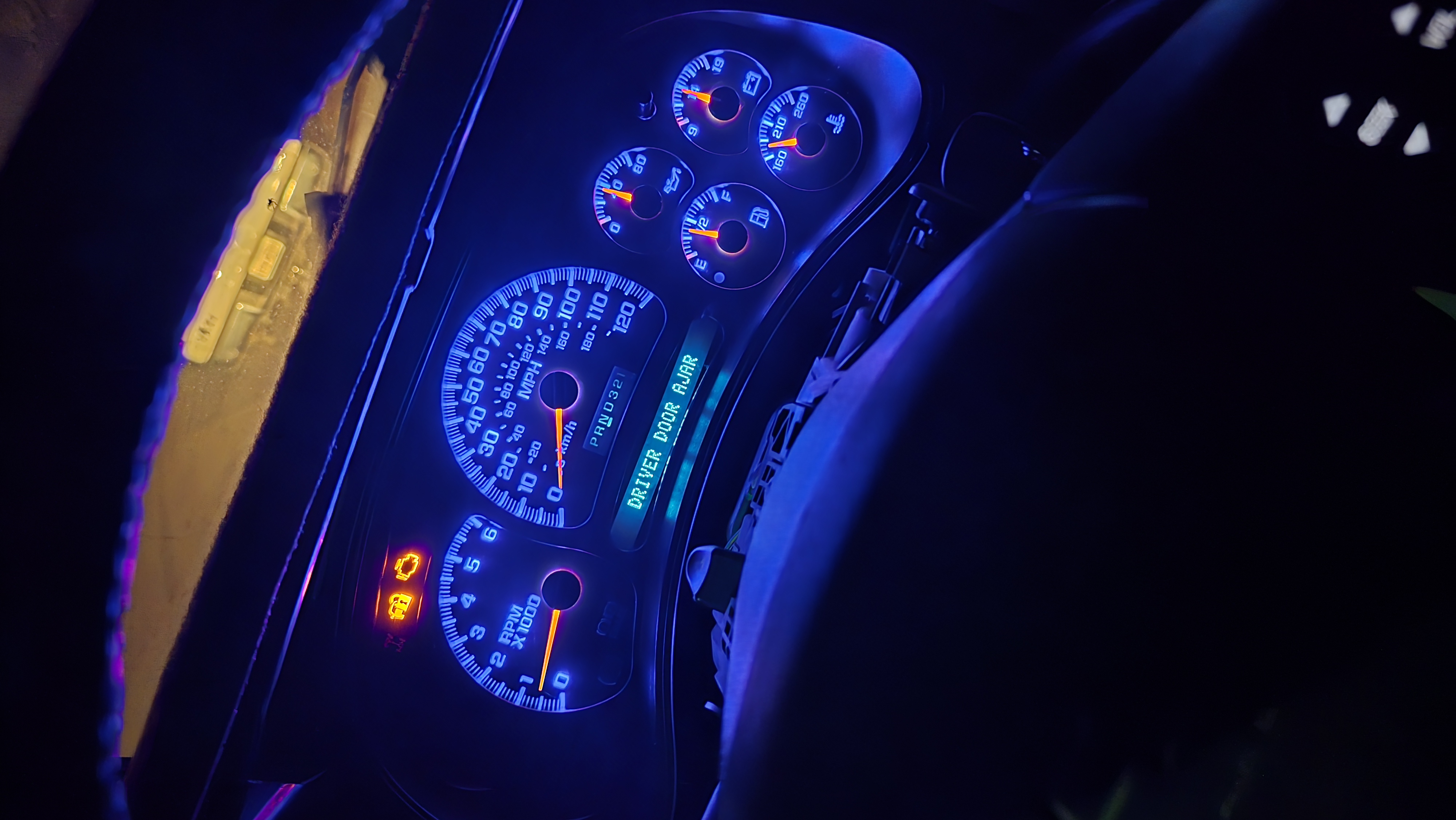 Chevrolet instrument cluster illuminated with custom blue LED lighting.