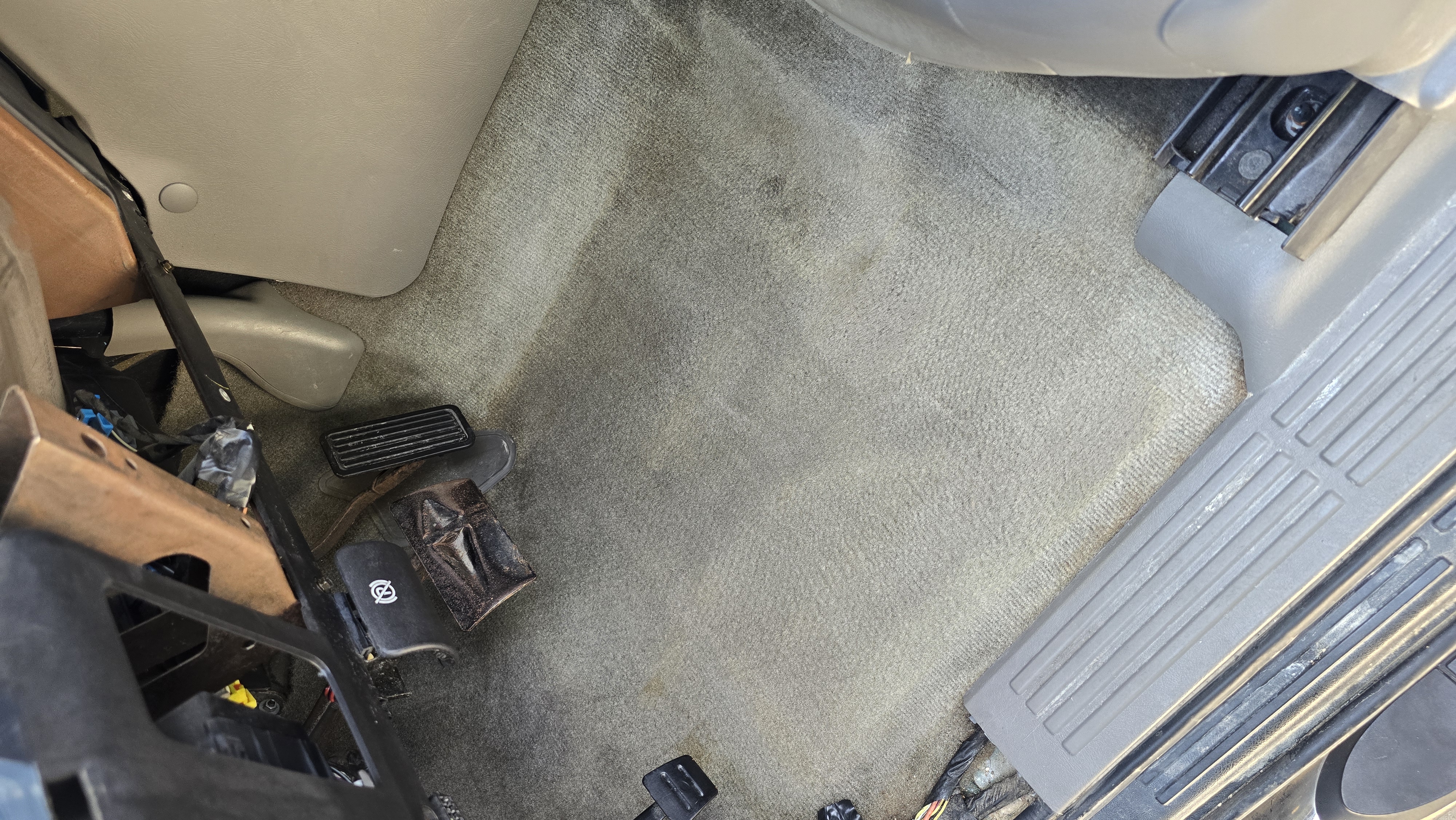 Driver's side carpet in a Chevrolet Tahoe after carpet extraction and deep cleaning.