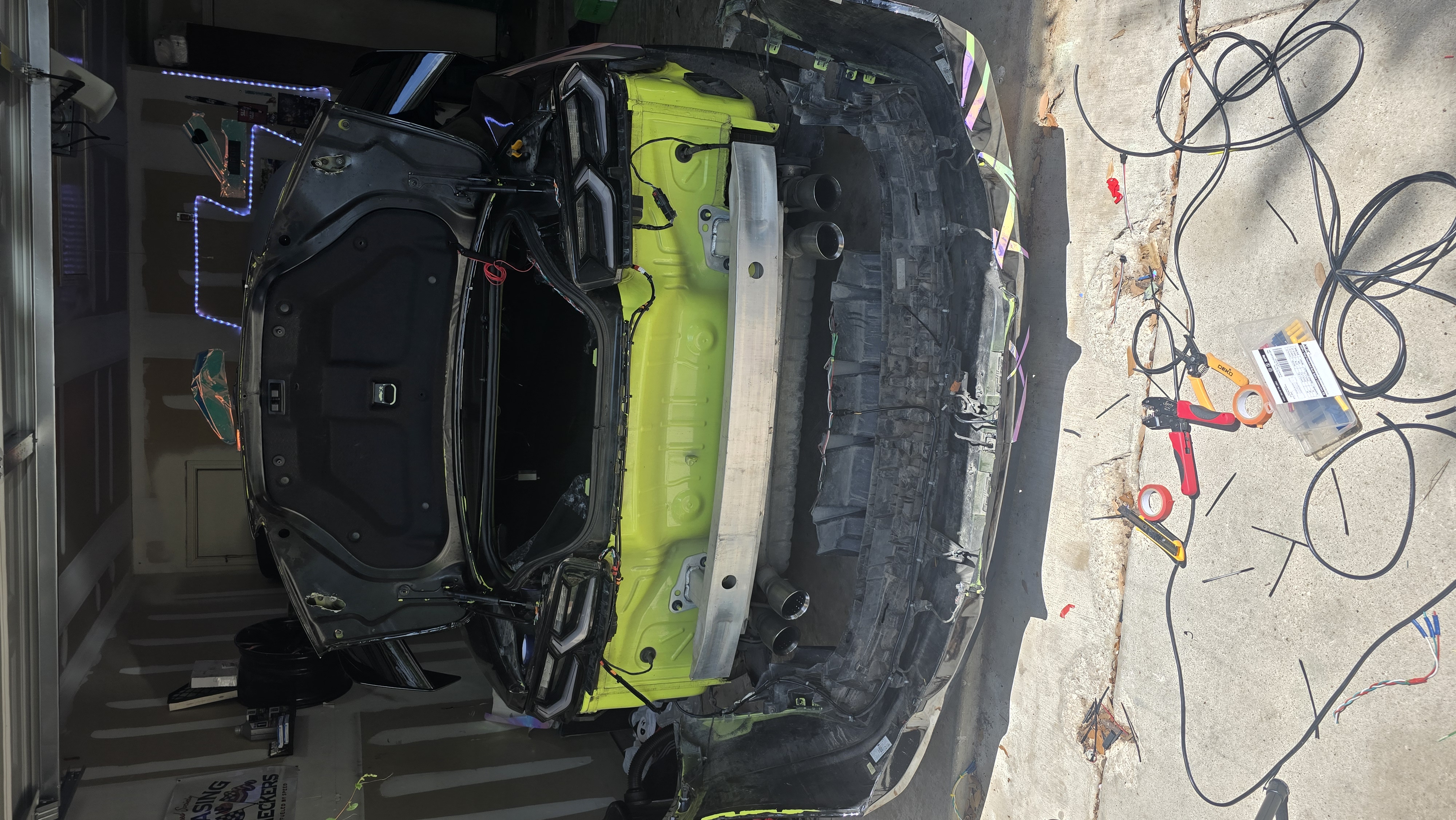 Clean custom wiring installation inside the rear of a sixth-generation Chevrolet Camaro during LED lighting installation.